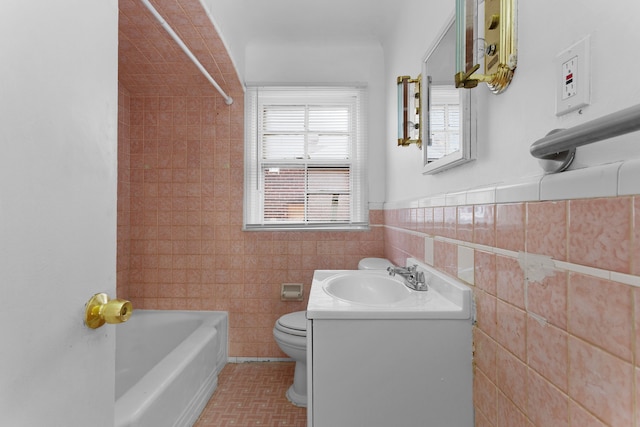 full bathroom with vanity, shower / bath combination, tile walls, and toilet