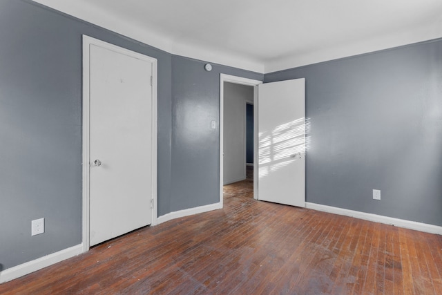 unfurnished room with dark hardwood / wood-style flooring