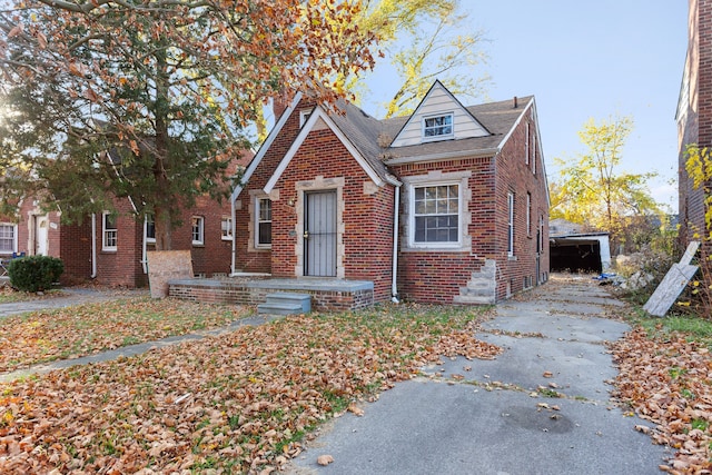 view of front of property featuring a garage and an outdoor structure