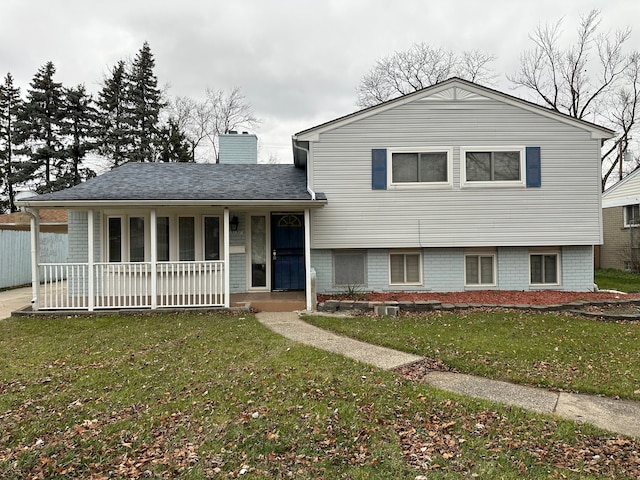 tri-level home with covered porch and a front yard