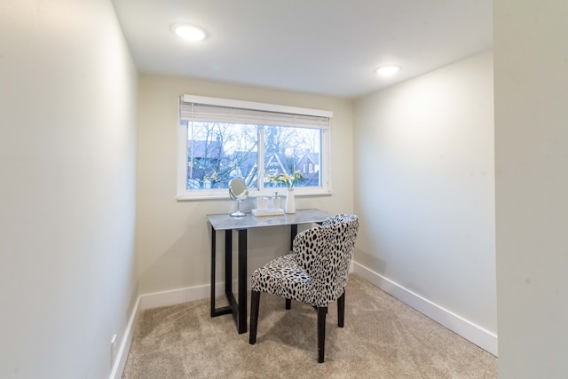 office area featuring light carpet