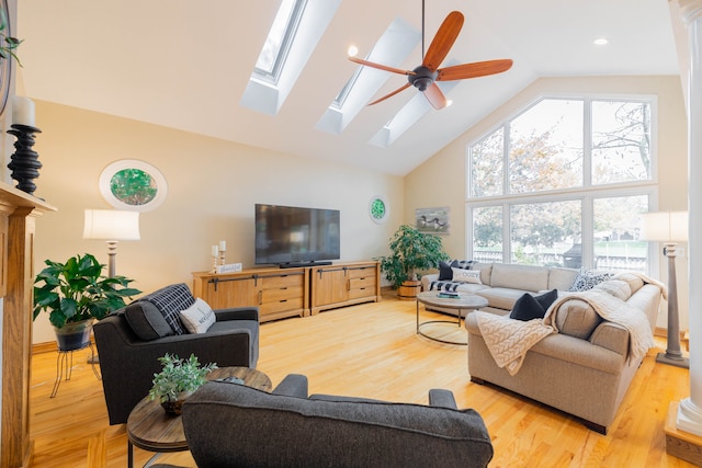 living room featuring ceiling fan, light wood-type flooring, and high vaulted ceiling