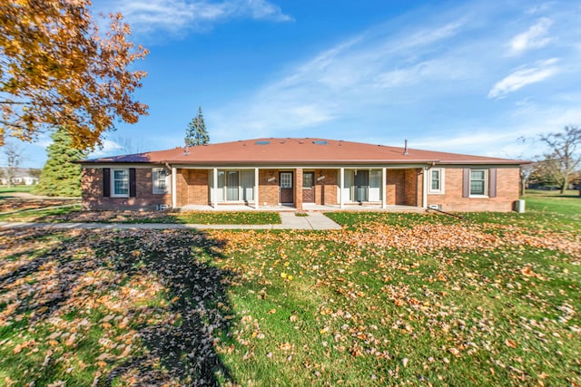 ranch-style home with a front lawn and a patio