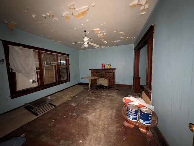 interior space featuring ceiling fan and a fireplace