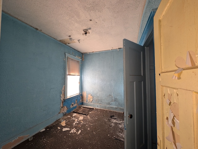 spare room with a textured ceiling