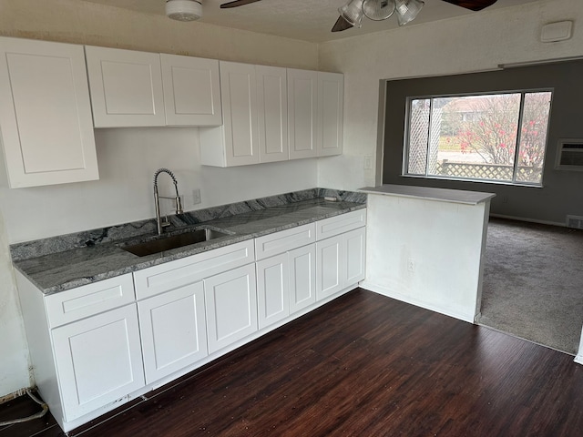 25741 Champaign St, Taylor, MI 48180 - kitchen featuring a sink, ceiling fan, white cabinets, dark wood-style flooring, and light stone counters