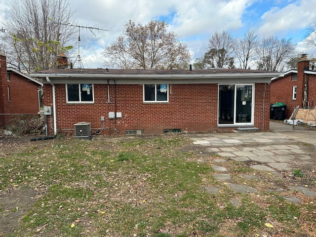 25741 Champaign St, Taylor, MI 48180 - back of property with a patio area, brick siding, cooling unit, and a lawn