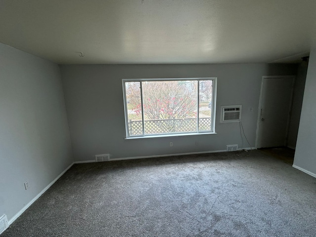 spare room with a wall mounted air conditioner and carpet floors