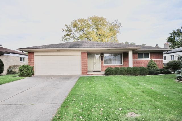 single story home with a front yard and a garage