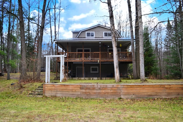 rear view of house featuring a wooden deck