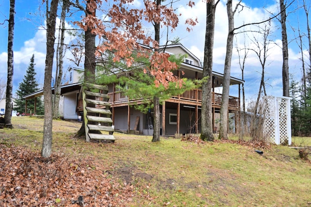 rear view of house featuring a wooden deck