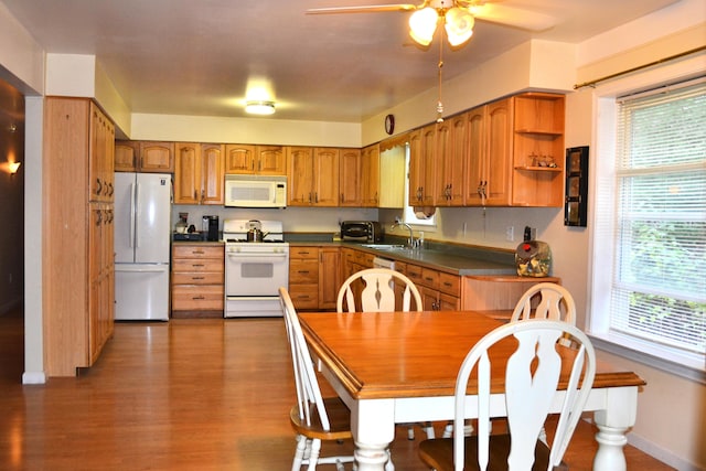 kitchen featuring hardwood / wood-style floors, plenty of natural light, ceiling fan, and white appliances