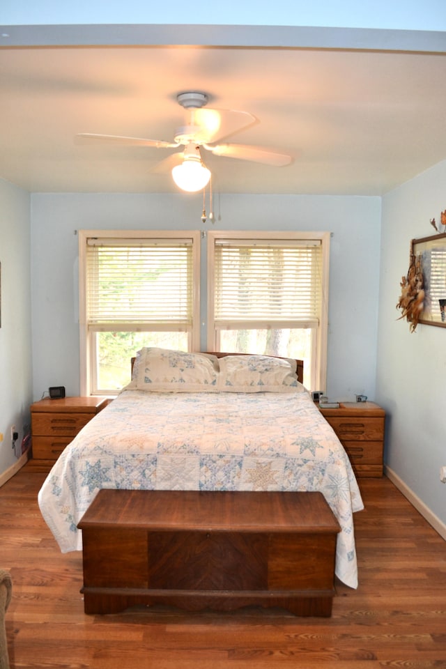 bedroom featuring ceiling fan and hardwood / wood-style flooring