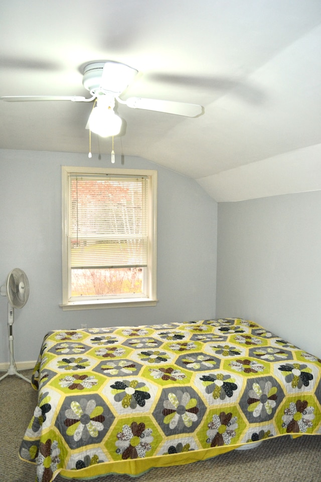 bedroom with carpet flooring, vaulted ceiling, and ceiling fan