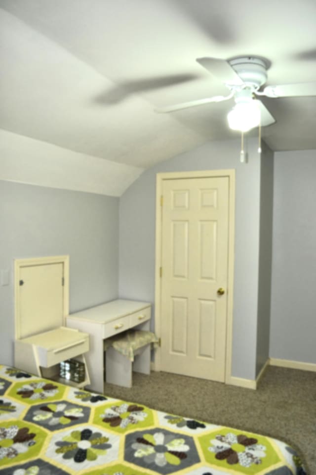 bedroom with carpet flooring, ceiling fan, and lofted ceiling