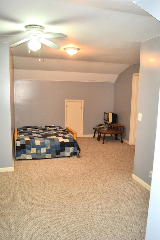 bedroom with ceiling fan, light colored carpet, and lofted ceiling