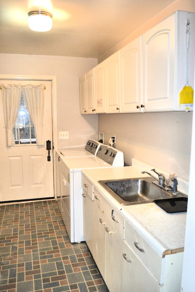 washroom featuring cabinets, washer and dryer, and sink