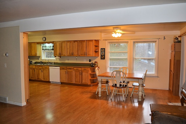 kitchen featuring dishwasher, ceiling fan, wood-type flooring, and sink