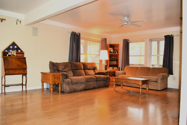 living room featuring beamed ceiling, hardwood / wood-style floors, and ceiling fan