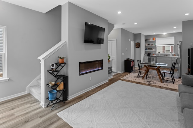 living room featuring light wood-type flooring and sink