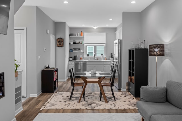 dining space with wood-type flooring and sink