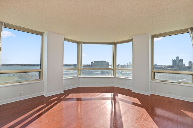 unfurnished sunroom featuring a wealth of natural light and a water view