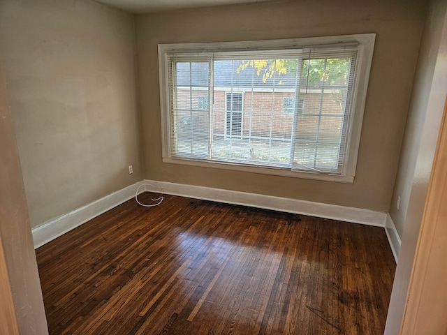 unfurnished room with dark hardwood / wood-style floors