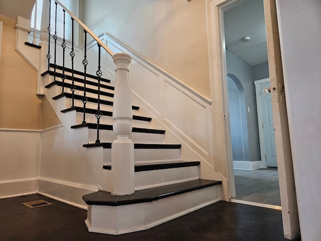 stairs featuring wood-type flooring