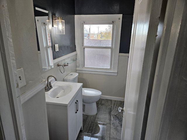 bathroom with tile patterned flooring, vanity, and toilet