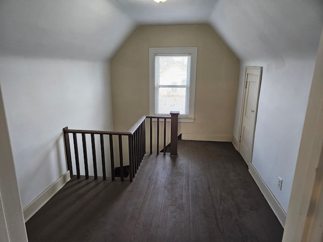 additional living space featuring dark hardwood / wood-style flooring and vaulted ceiling