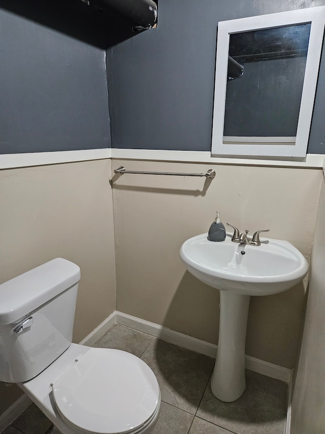 bathroom featuring tile patterned flooring and toilet