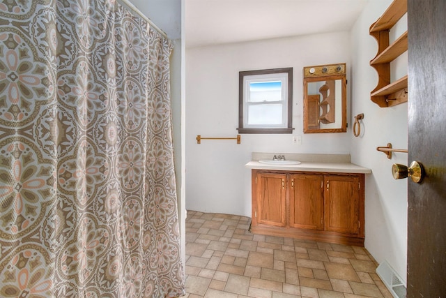 bathroom featuring vanity and a shower with shower curtain