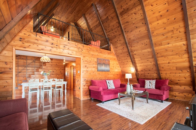 living room with wood walls, dark hardwood / wood-style flooring, high vaulted ceiling, and beamed ceiling