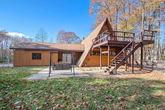 back of property featuring a patio area, a deck, and a yard