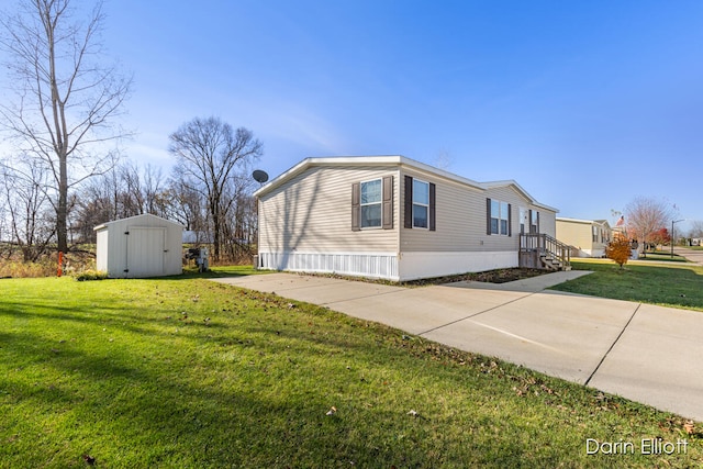 view of side of home with a storage unit and a lawn