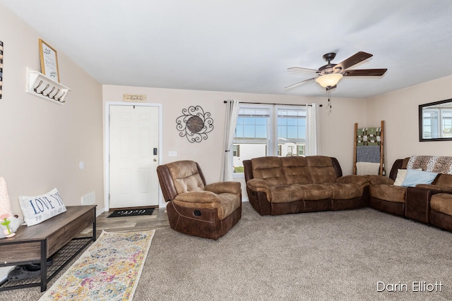 living room with ceiling fan and carpet