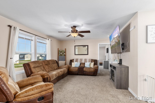 carpeted living room featuring ceiling fan