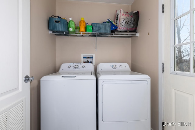 clothes washing area with washer and dryer