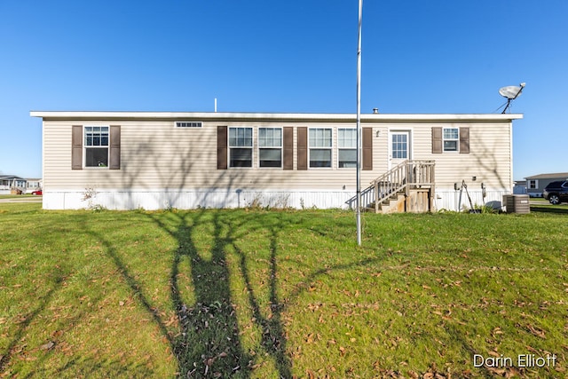 view of front of property featuring a front yard and central air condition unit