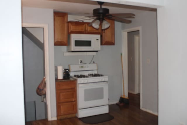 kitchen with ceiling fan, dark hardwood / wood-style flooring, and white appliances