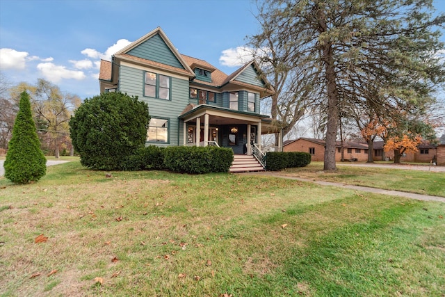 view of front of house with covered porch and a front yard