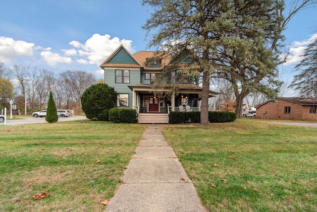 view of front of house with a porch and a front yard