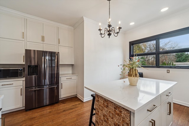 kitchen featuring dark hardwood / wood-style flooring, white cabinetry, crown molding, and appliances with stainless steel finishes