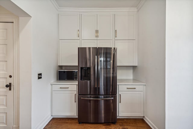 kitchen featuring dark hardwood / wood-style flooring, stainless steel appliances, and white cabinetry