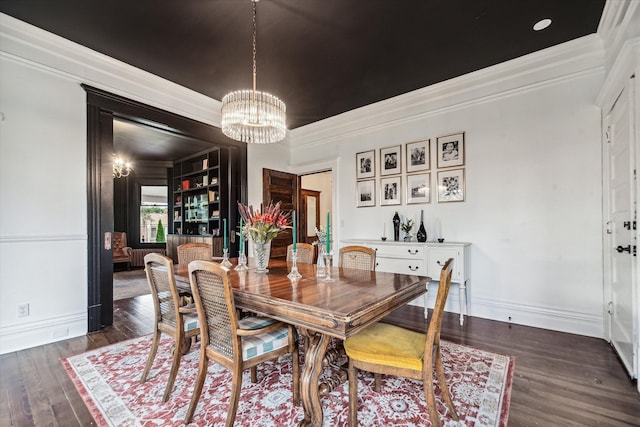 dining space featuring ornamental molding, dark wood-type flooring, and a notable chandelier