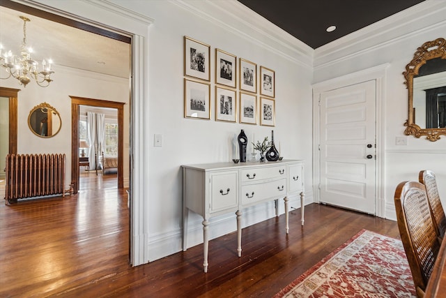 interior space with a notable chandelier, dark hardwood / wood-style flooring, radiator heating unit, and crown molding