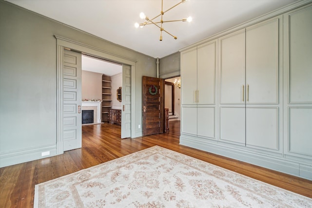 unfurnished bedroom featuring hardwood / wood-style floors and an inviting chandelier