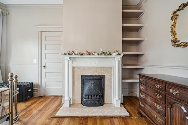 living room with light hardwood / wood-style floors and ornamental molding