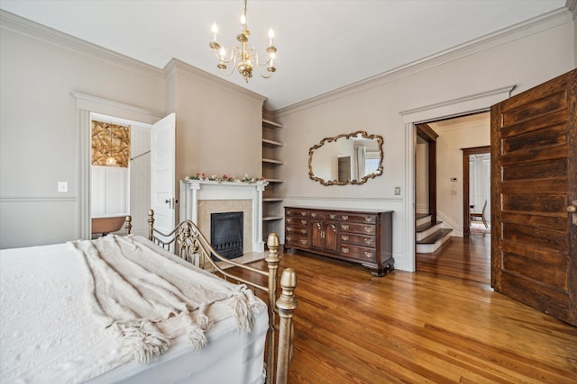 bedroom with dark hardwood / wood-style flooring, an inviting chandelier, and ornamental molding