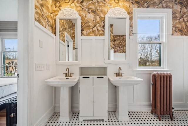 bathroom with radiator and double sink